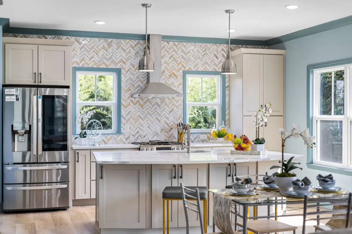 Spacious modern kitchen with a large island, pendant lights and patterned backsplash